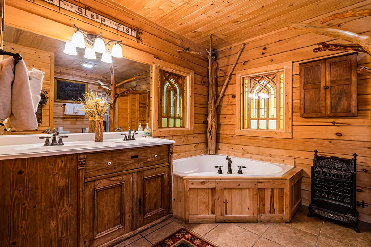 A luxurious bathroom with a double sink vanity, a stunning wooden bathtub perfect for soaking, stained glass windows casting soft light, and intricate wooden accents throughout. The serene atmosphere invites relaxation and indulgence.